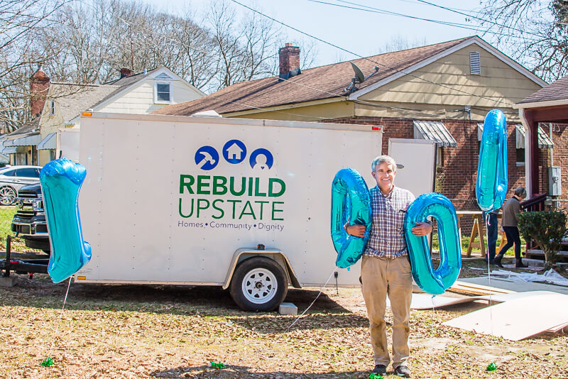 Doug poses with his award on a build site.