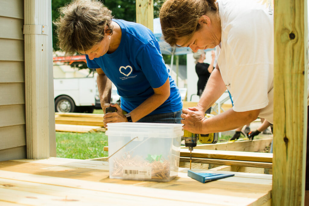 Michelle builds a ramp while volunteering.